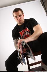 Alex Sitting With Pistol Pose